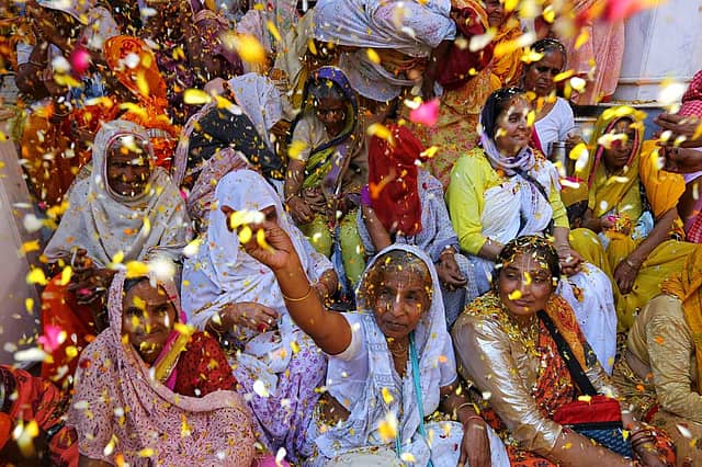 Widows and devotees celebrate Holi with colours and flowers  at Gopinath Mandir, Vrindavan, March 6, 2023
