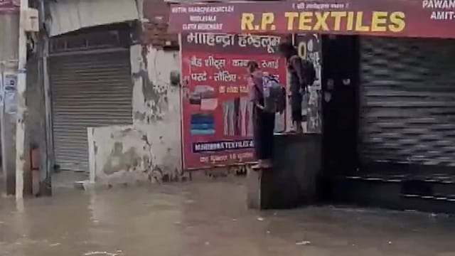 Children face difficulties reaching schools amid waterlogging in Ambala. Children face difficulties reaching schools amid waterlogging in Ambala.