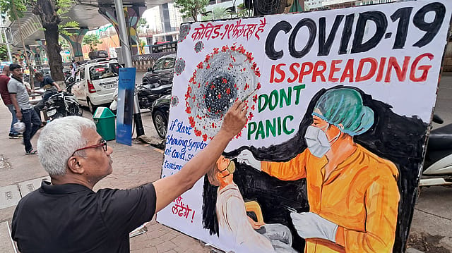 A teacher of Gurukul School of Art makes an awareness painting of COVID 19, in Mumbai. A teacher of Gurukul School of Art makes an awareness painting of COVID 19, in Mumbai.