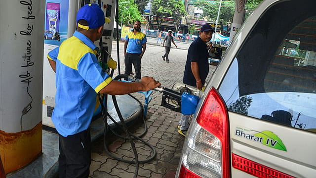 A worker fills petrol in a motorcycle at a fuel station, in Siliguri. A worker fills petrol in a motorcycle at a fuel station, in Siliguri.
