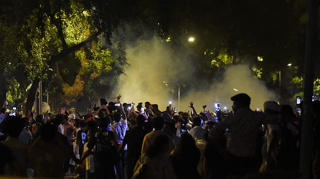 Smoke rises as security personnel fire tear gas shells to disperse potesters during their protest at Jantar Mantar in support of the Cockroach Janata Party (CJP), demanding the resignation of Union Education Minister Dharmendra Pradhan over alleged examination irregularities and NEET paper leak, in New Delhi on Wednesday. Smoke rises as security personnel fire tear gas shells to disperse potesters during their protest at Jantar Mantar in support of the Cockroach Janata Party (CJP), demanding the resignation of Union Education Minister Dharmendra Pradhan over alleged examination irregularities and NEET paper leak, in New Delhi on Wednesday.