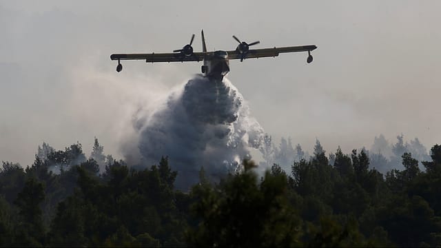 File photo: A firefighting aircraft drops water over a wildfire near the village of Stavros on the Greek island of Evia File photo: A firefighting aircraft drops water over a wildfire near the village of Stavros on the Greek island of Evia